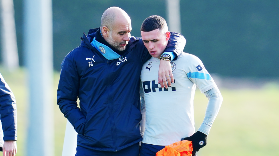 Pep shares a thought with Phil Foden