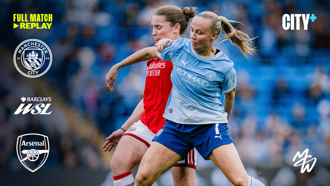 Two female footballers, one in a Manchester City kit and the other in an Arsenal kit, competing for the ball during a match with Manchester City and Barclays WSL logos visible.