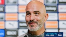 A bald man with a beard, smiling in front of a backdrop with logos. The image features a 'Manager's Preview' text and a sponsored logo.