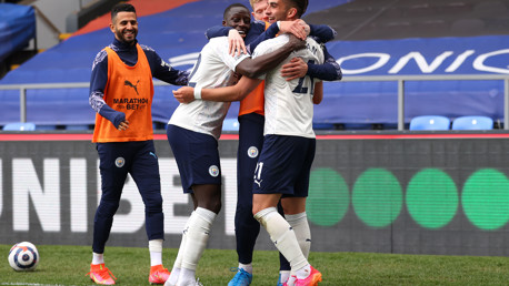 Substitutes Kevin De Bruyne and Riyad Mahrez congratulate Ferran Torres