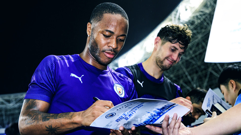 PEN PALS : Raheem Sterling and John Stones sign on the dotted line!
