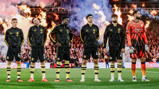 Manchester City players standing in a line wearing black jackets, with a goalkeeper in an orange kit, surrounded by flames in the background.
