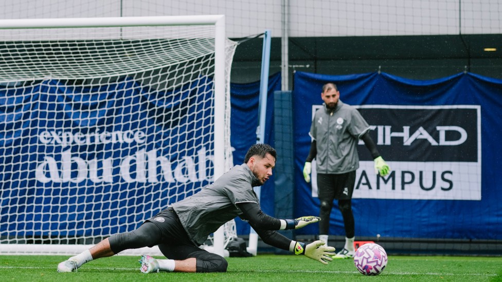 SAFE HANDS : James Trafford makes the save