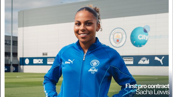 A person in a blue Manchester City tracksuit stands smiling on a field. The background shows the Manchester City logo and the text 'First pro contract Sacha Lewis' displayed on the image.