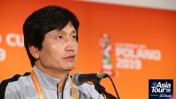 Individual speaking at a press conference for the 2019 FIFA U-20 World Cup. Background features event branding for the Asia Tour '26.