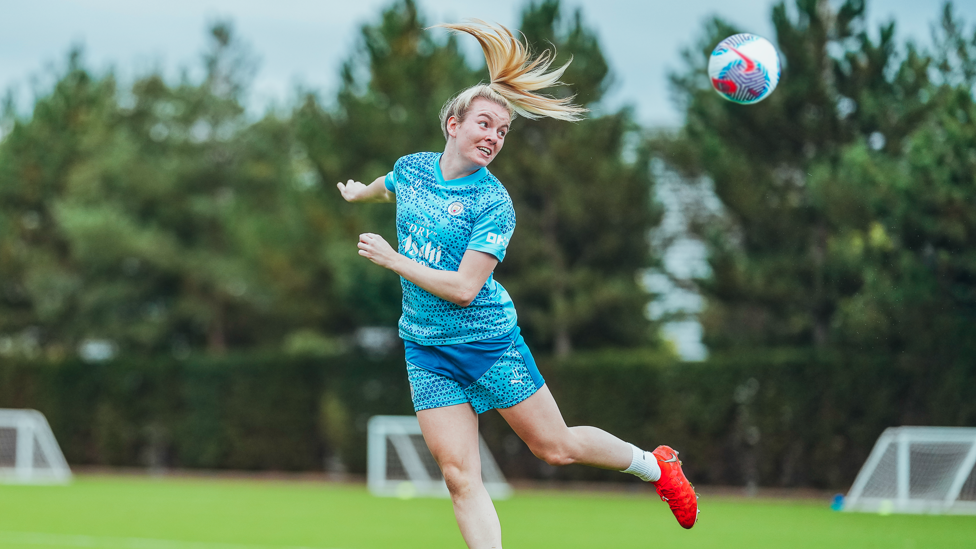 HEADS UP: Lauren Hemp powers in a header.