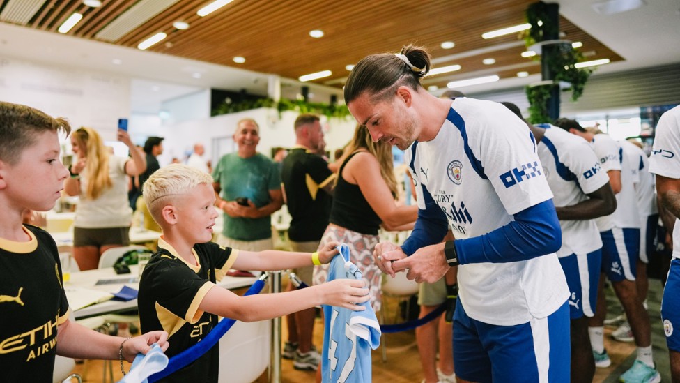 HELLO! : Jack Grealish taking some time with the fans on his way out to training.