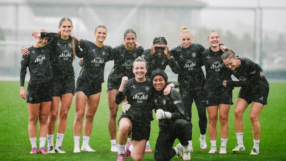 HERE COMES THE RAIN AGAIN: The girls have some fun in the Manchester downpour