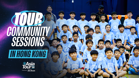 Group of children in blue 'Manchester City' t-shirts with two adults, against a backdrop with 'Tour Community Sessions in Hong Kong' text.