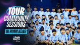 Group of children in blue 'Manchester City' t-shirts with two adults, against a backdrop with 'Tour Community Sessions in Hong Kong' text.