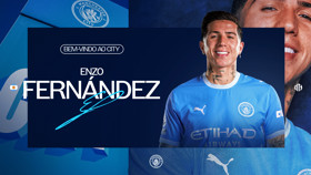A graphic welcoming a player named Enzo Fernandez to Manchester City, featuring the club's logo and player in the foreground wearing the team's blue kit.