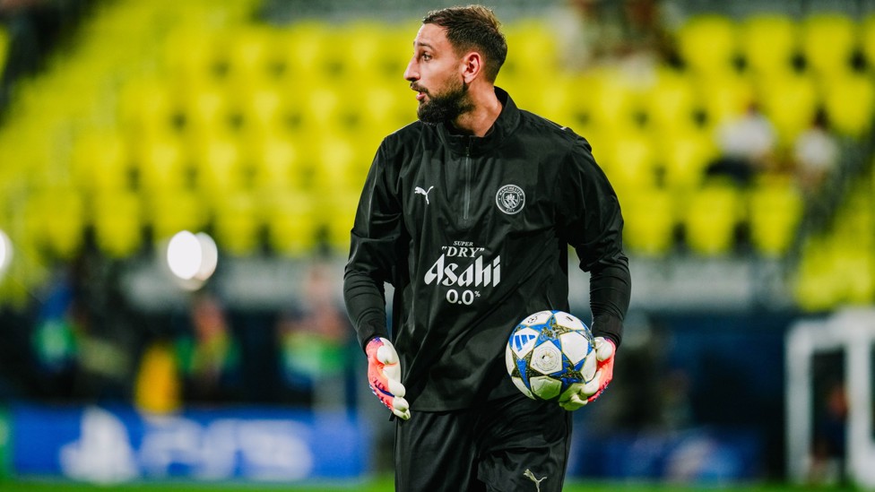 SAFE HANDS : Donnarumma gets a feel of the ball during the pre-match warm up.