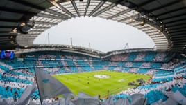 Supporters waving flags at the Etihad stadium