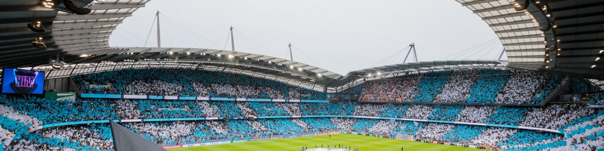 Supporters waving flags at the Etihad stadium