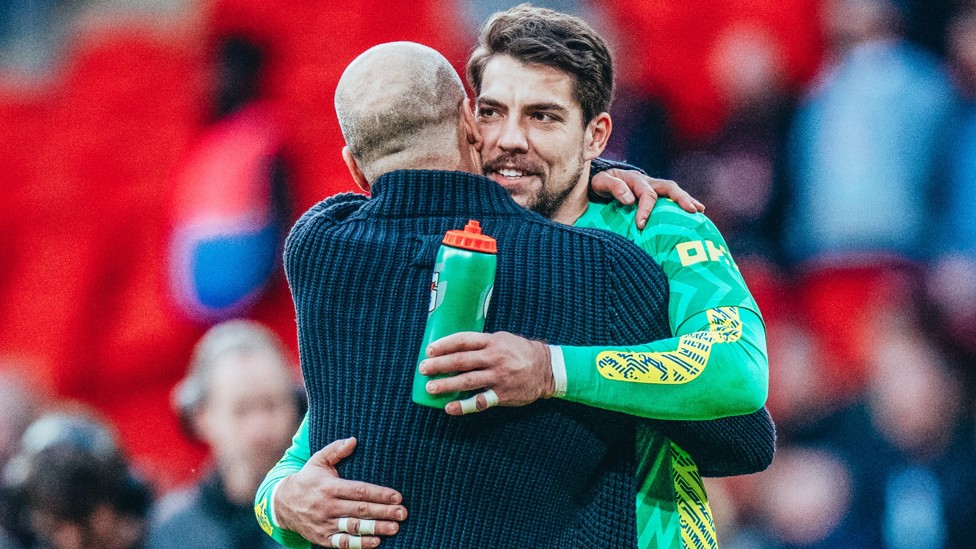 BOSSED IT : Pep Guardiola gives his goalkeeper a hug