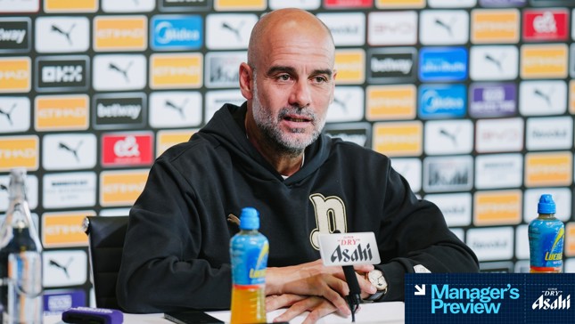 A person giving a press conference at a table with microphones. The background features sponsors like Puma, Etihad, and Betway. Labels such as 'Manager's Preview' and 'Asahi' are visible.