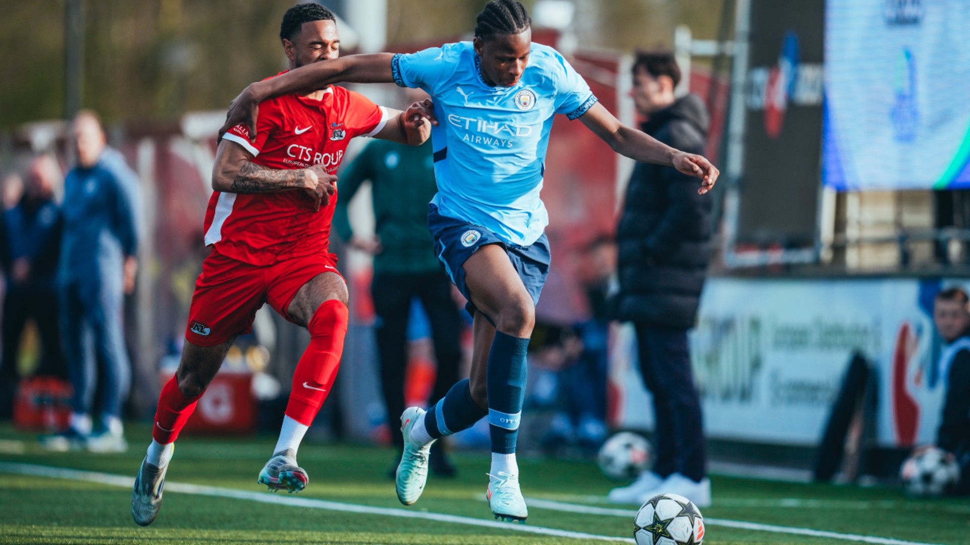 DARTING DEFENDER : Stephen Mfuni drives forward on the left. 