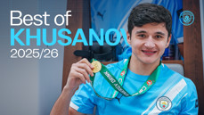 A Manchester City player holding a gold medal, wearing a Manchester City jersey, with the text 'Best of Khusanov 2025/26'.