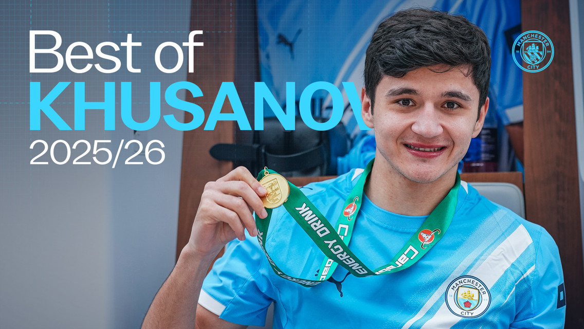 A Manchester City player holding a gold medal, wearing a Manchester City jersey, with the text 'Best of Khusanov 2025/26'.