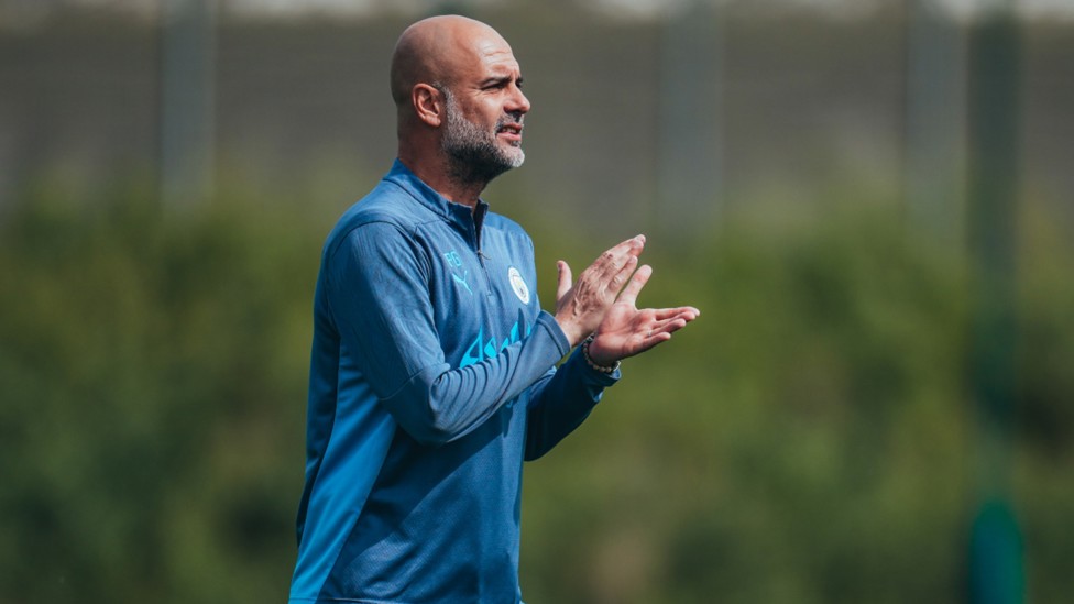 THE BOSS: Pep Guardiola offers words of encouragement during Monday's session.