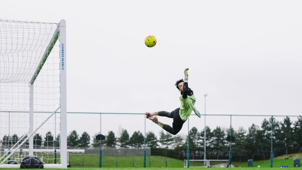 THIS CHARMING MAN: Trafford leaps to punch the ball away in training