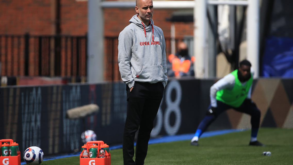 Pep Guardiola watches on from the dugout