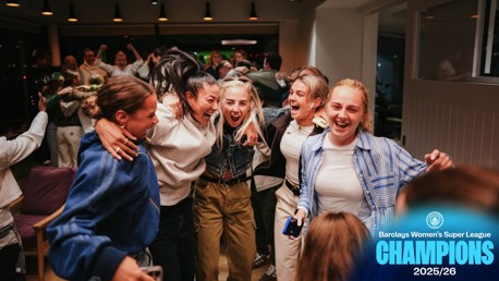 Group of people celebrating indoors, associated with Barclays Women's Super League Champions 2025/26. Manchester City logo present.