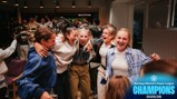 Group of people celebrating indoors, associated with Barclays Women's Super League Champions 2025/26. Manchester City logo present.