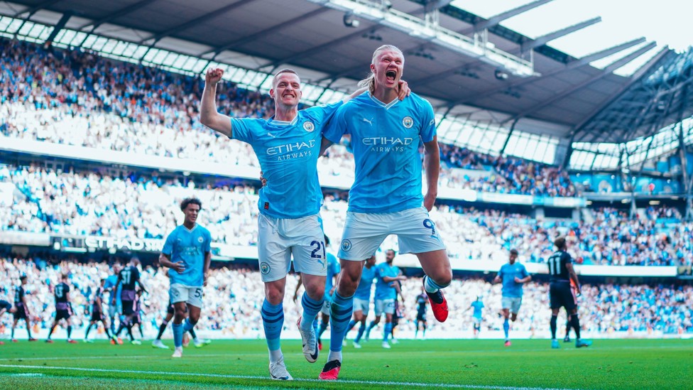 GET IN : Sergio Gomez and Erling Haaland celebrate the striker's hat-trick against Fulham