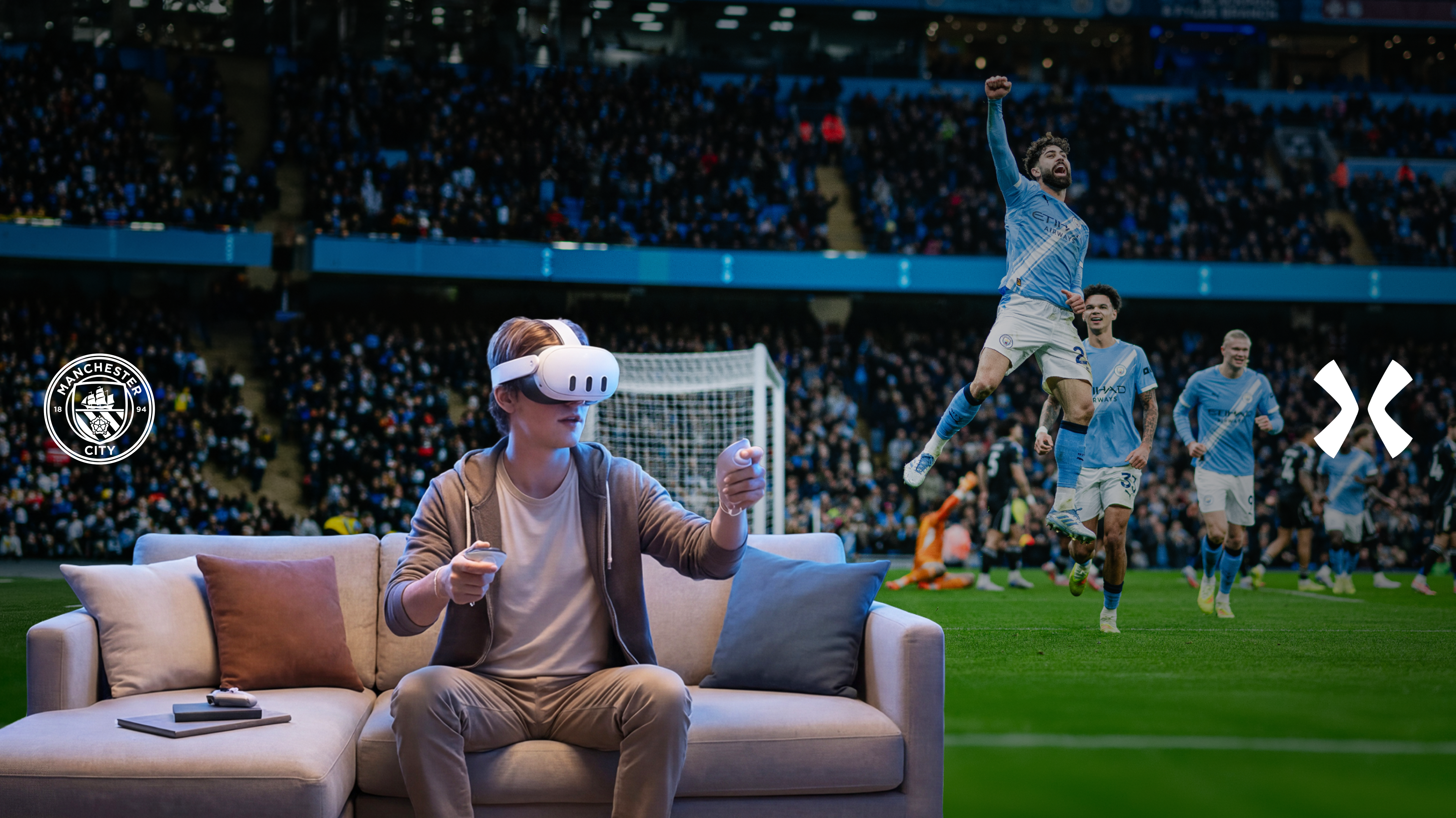 A person wearing a VR headset interacts with a virtual Manchester City soccer game while sitting on a couch. The stadium and team celebrate in the background. Logos of Manchester City and OKX are visible.