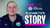 Blurred person wearing Manchester City hoodie in front of 'We Are City in the Community' text, promoting Elizabeth's Story.
