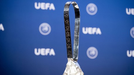 Image of the UEFA Women's Champions League trophy with the UEFA logo in the background.