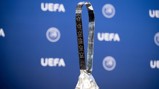 Image of the UEFA Women's Champions League trophy with the UEFA logo in the background.