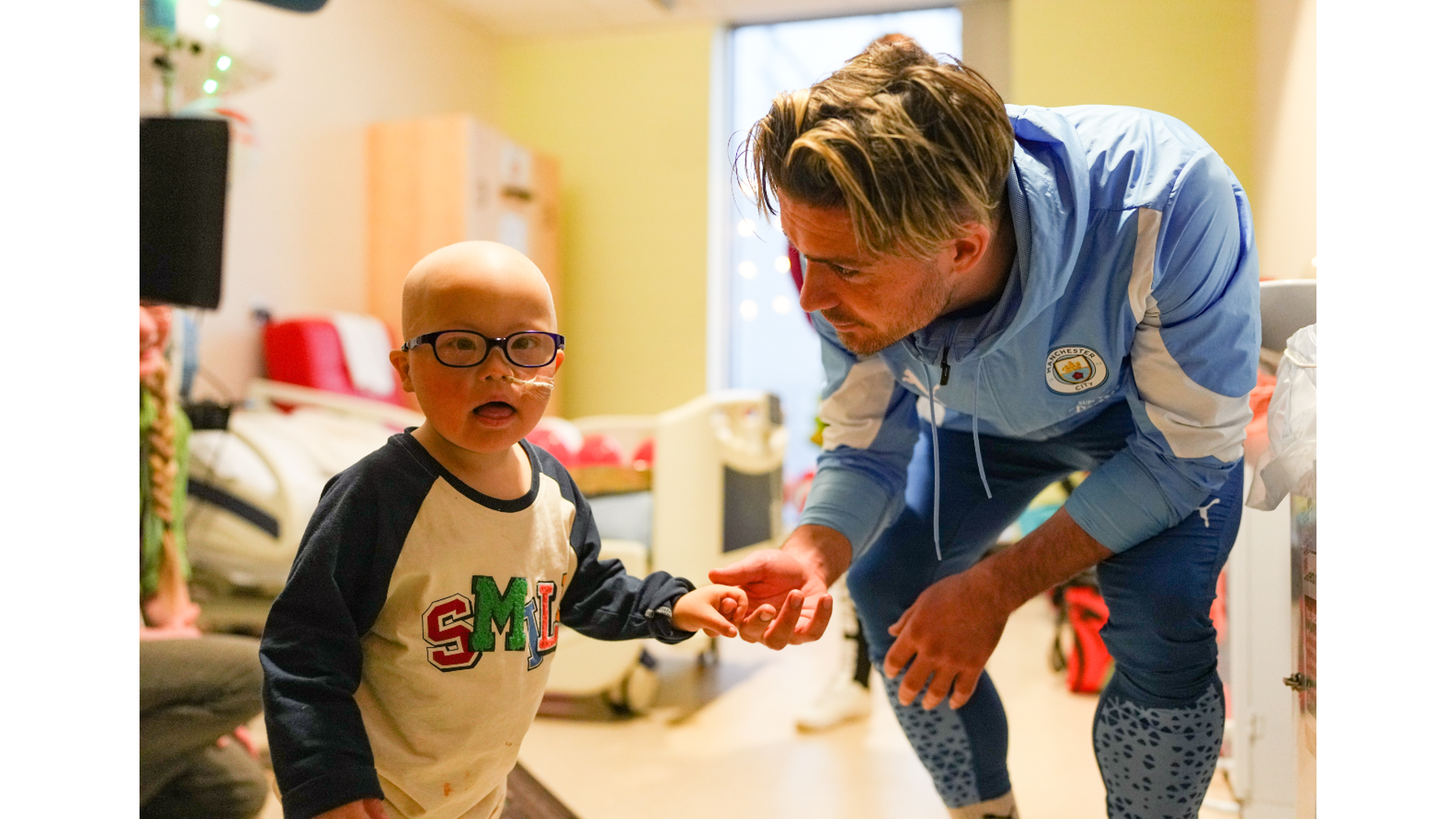 SMILES BETTER: Jack Grealish meets another brave youngster.