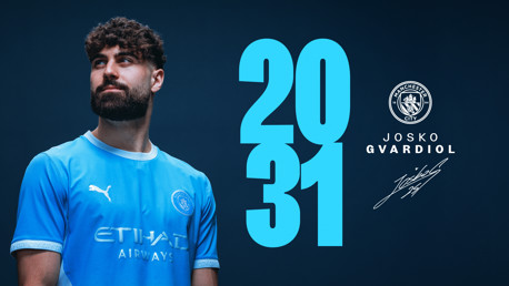 A person wearing a Manchester City jersey featuring Puma and Etihad logos stands next to a large '2031' text. The Manchester City crest is displayed, along with the name 'Josko Gvardiol' and a signature.