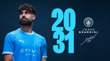 A person wearing a Manchester City jersey featuring Puma and Etihad logos stands next to a large '2031' text. The Manchester City crest is displayed, along with the name 'Josko Gvardiol' and a signature.