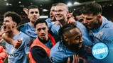 Manchester City players celebrating a victory at a stadium holding an 'Official Verdict' badge in front of a crowd.