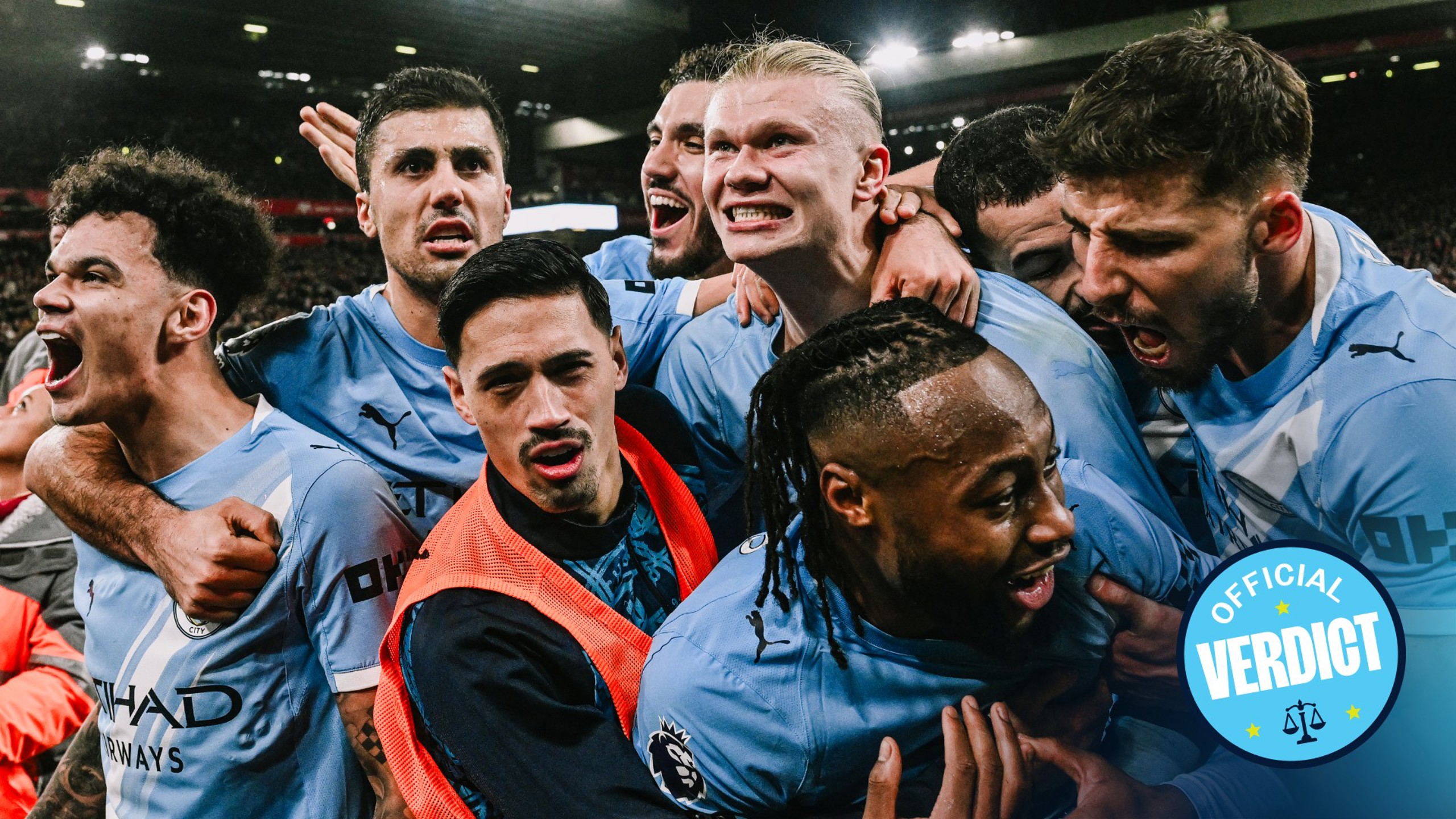 Manchester City players celebrating a victory at a stadium holding an 'Official Verdict' badge in front of a crowd.