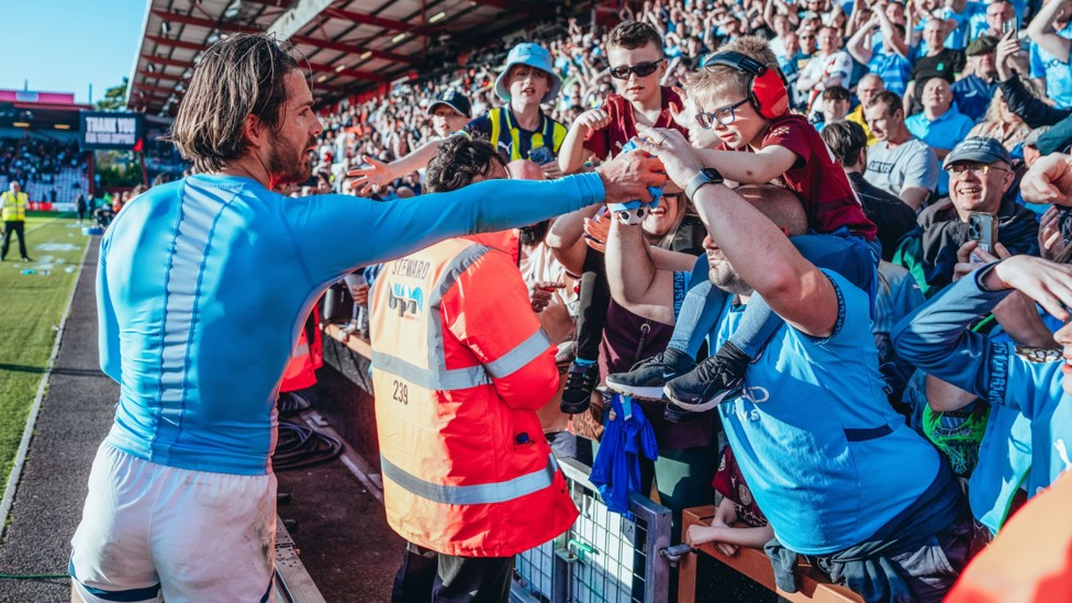FAN FARE : Jack Grealish gives his shirt to a young fan