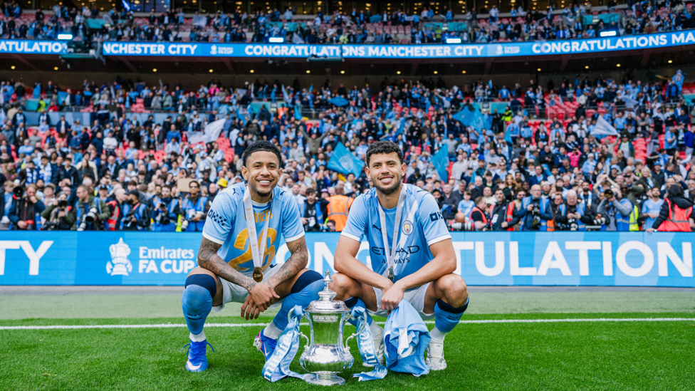 STRIKE A POSE : Savinho and Nunes celebrate with the trophy.