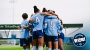 A group of female football players huddling in celebration wearing light blue jerseys numbered 4, 5, and 20. Text overlay reads 'Official Verdict.'