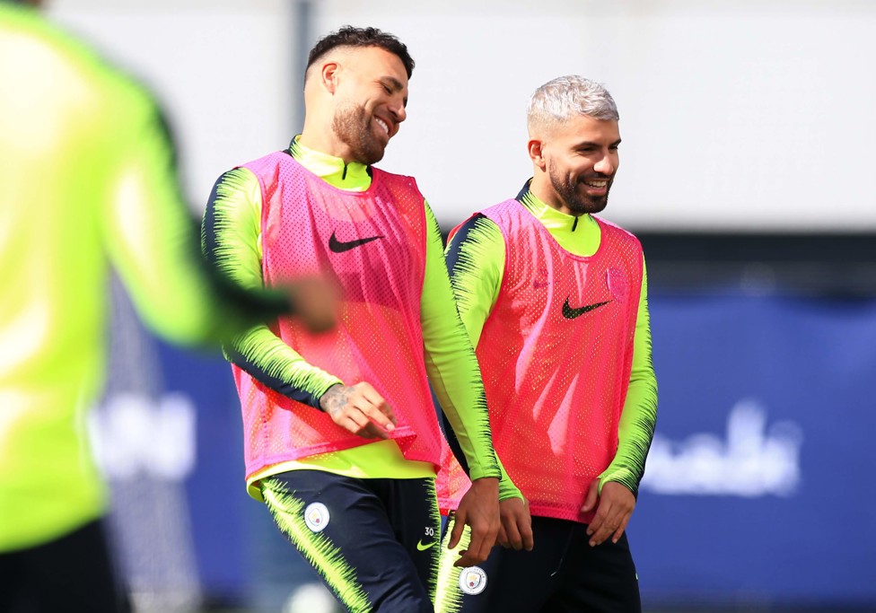 PRETTY IN PINK : Sergio Aguero and Nicolas Otamendi take to the training pitches