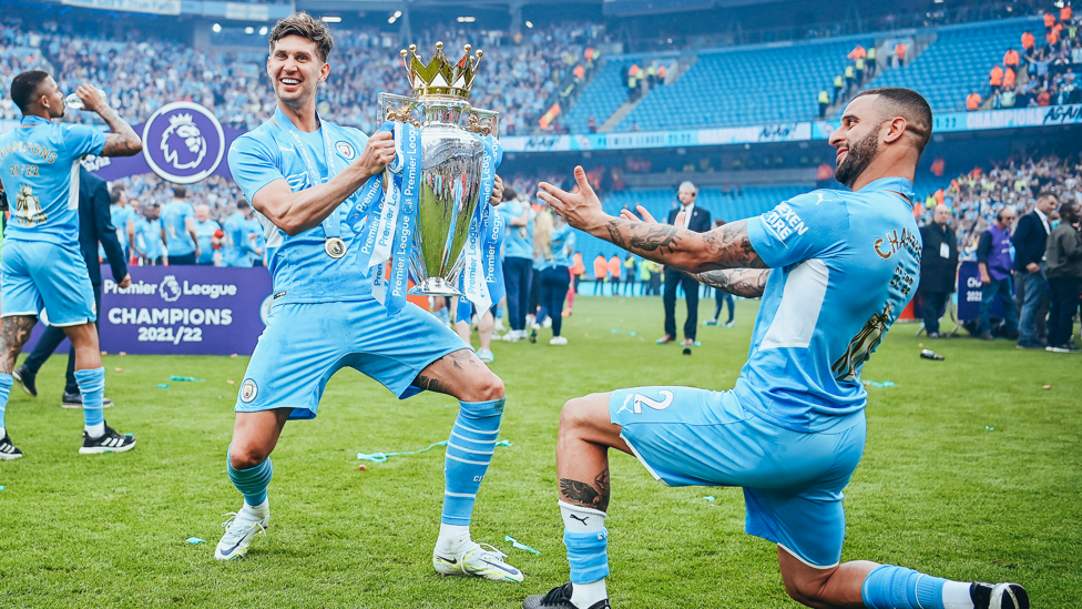WHAT A GENT : Walker presents Stones with their fourth Premier League title in 2021/22. 
