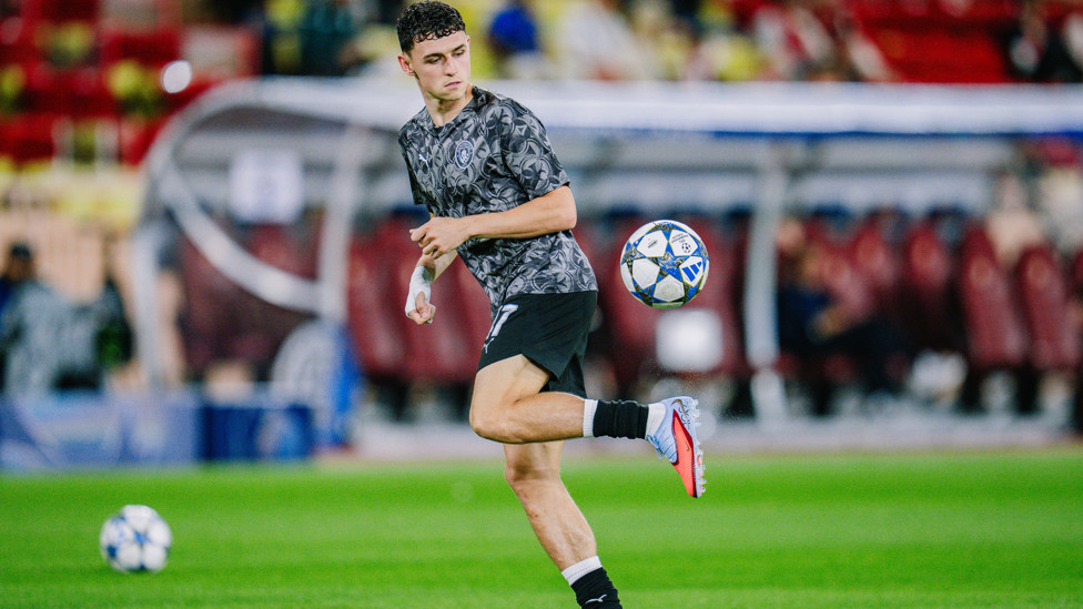 PHIL-ING GOOD : Foden gets in the mood during the pre-match warm up.