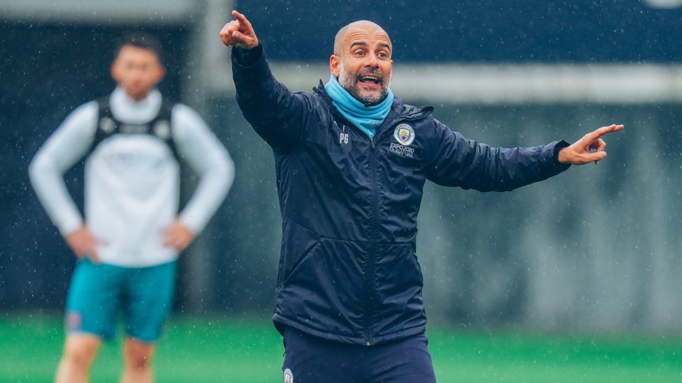 BOSSING IT : Pep Guardiola speaks to the players during the session