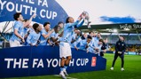 Youth team celebrating winning the FA Youth Cup, lifting the trophy at Joie Stadium.