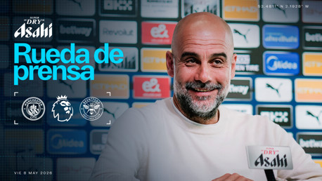 Blurred individual at a press conference with Manchester City and Brentford logos, Premier League logo, and Asahi branding, dated May 8, 2026.
