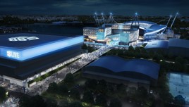 Aerial view of a stadium complex at night, featuring a large building marked 'Co-op Live' with a crowd gathered.