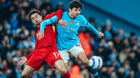 TUSSLE: Khusanov battles for the ball.