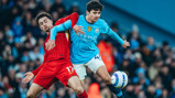 TUSSLE: Khusanov battles for the ball.
